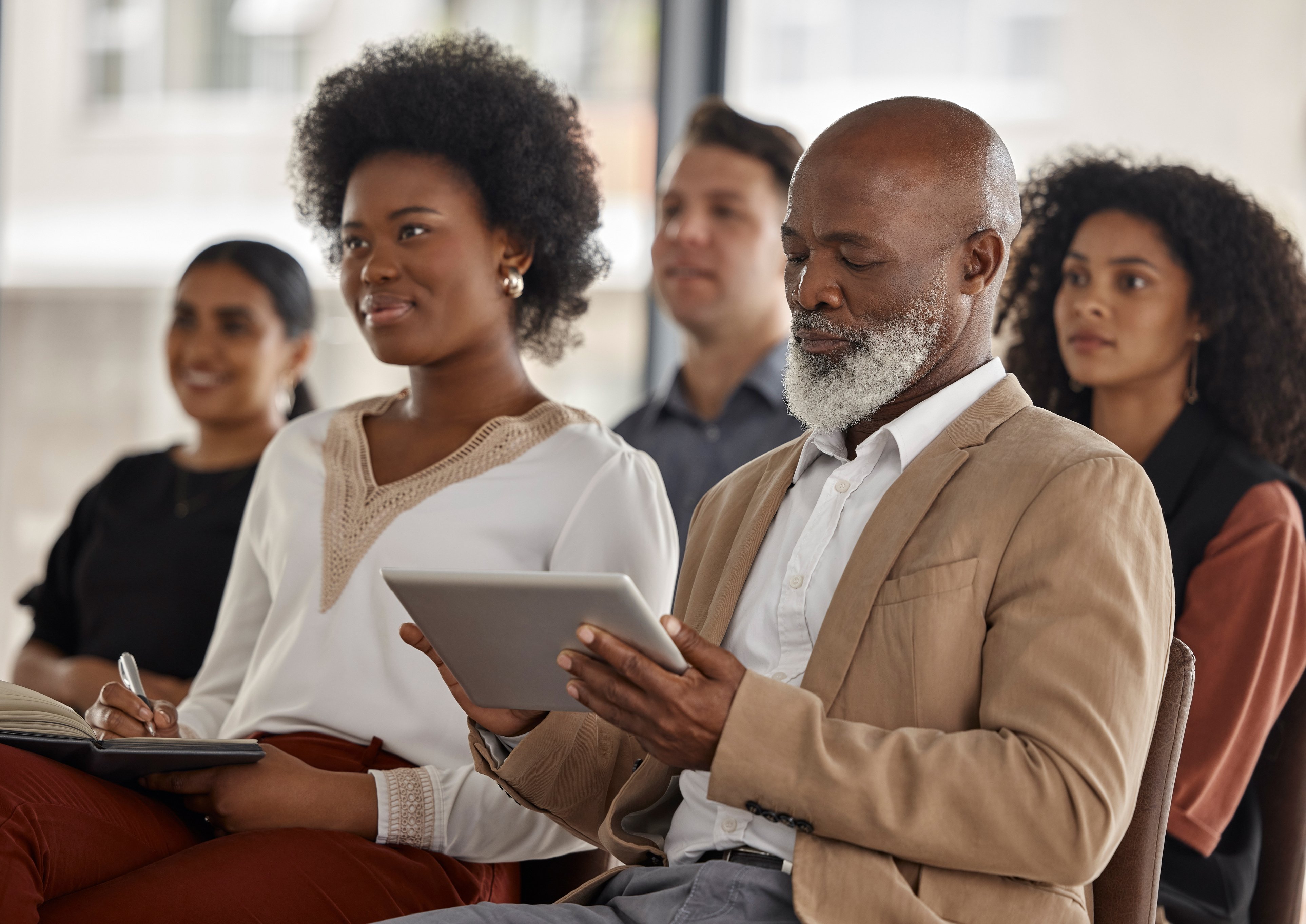 Seminar, Listening or Business People Writing Notes in Meeting for Education or Coaching in Company. Mentorship, Learning or Employees in Group Training Presentation with Tablet or Notebook in Office